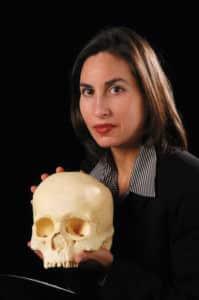 CHASS researcher Ann Ross and a human skull. PHOTO BY ROGER WINSTEAD