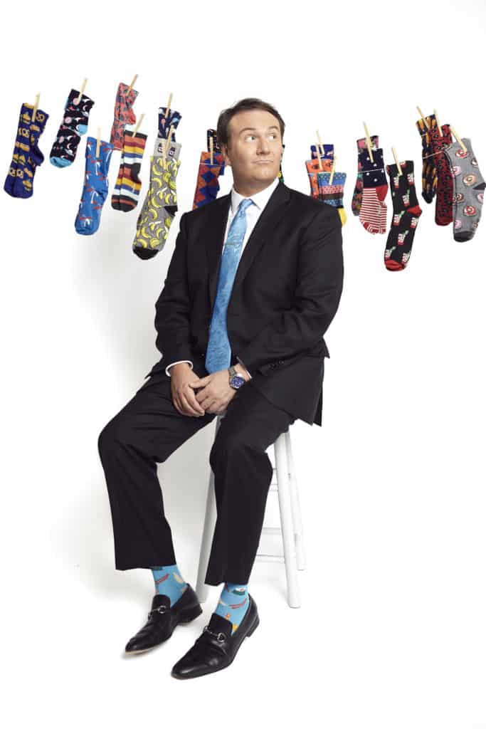 Local news anchor, Bill Young, posing with his sock collection